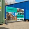 Printed Heras fencing banner installed on temporary construction site fencing.
