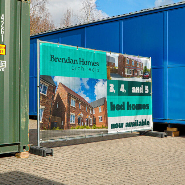 Printed Heras fencing banner installed on temporary construction site fencing.